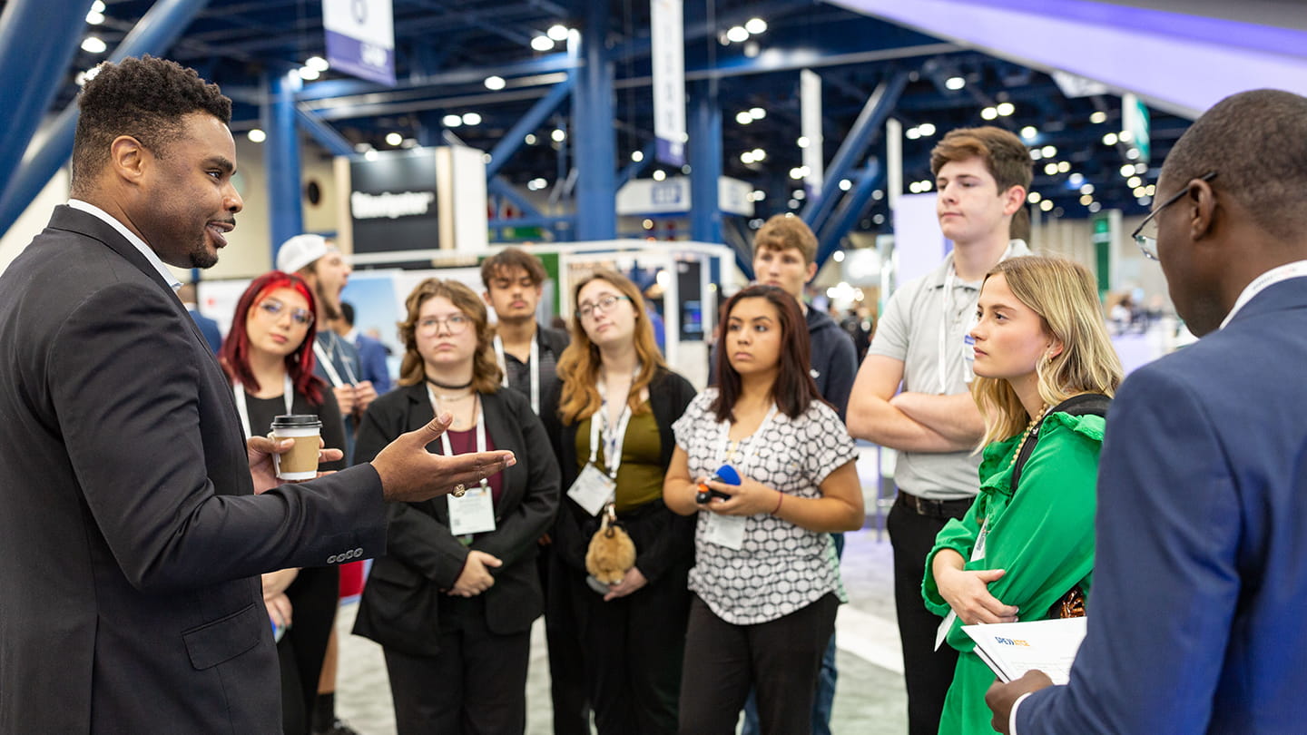 Uchenna Odi visits with local area high school students as part of SPE’s Energy4Me program to bring energy education to students.