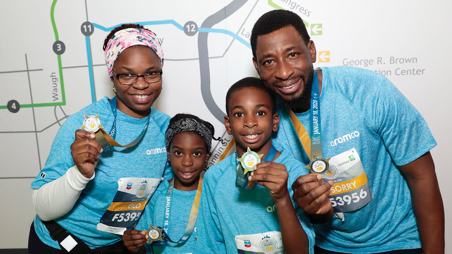 Aramco 5K runners show their finisher medals