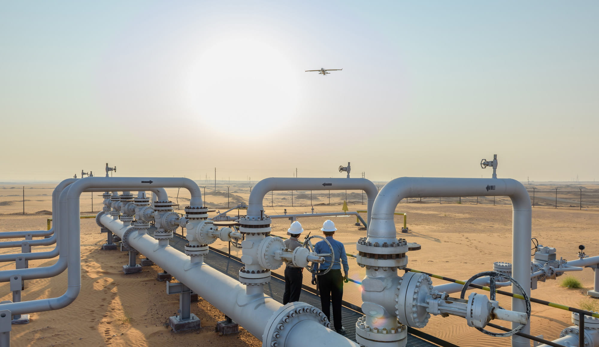A fixed-wing drone flies over the Khurais field